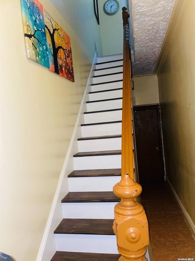 staircase featuring tile patterned flooring