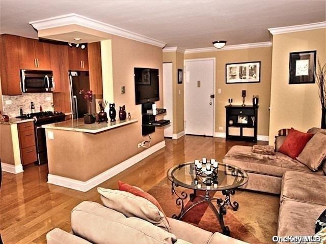 living room with dark hardwood / wood-style flooring and crown molding