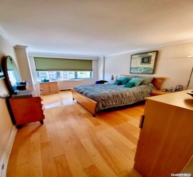 bedroom with wood-type flooring and ornamental molding