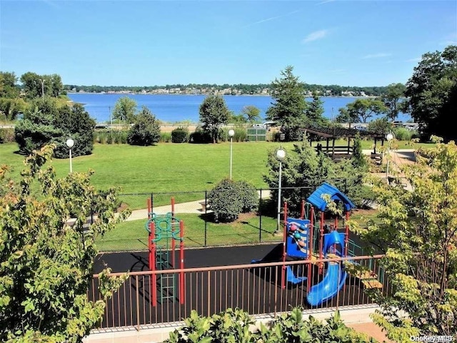 view of jungle gym with a water view and a lawn