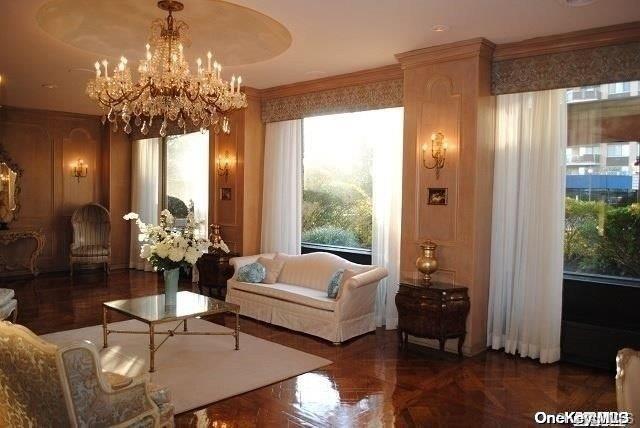 interior space featuring dark parquet floors, a chandelier, and ornamental molding