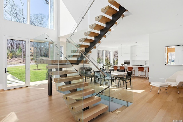 1739 Millstone Rd, Sag Harbor, NY 11963 - staircase featuring a high ceiling and wood finished floors
