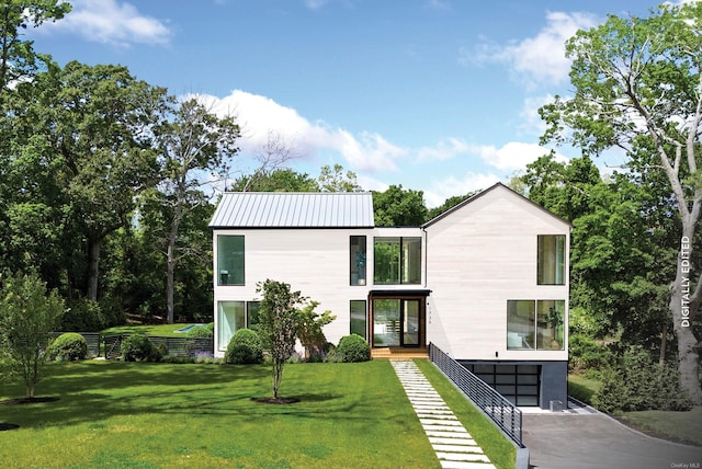 1739 Millstone Rd, Sag Harbor, NY 11963 - view of front of house featuring a front yard, an attached garage, driveway, and metal roof