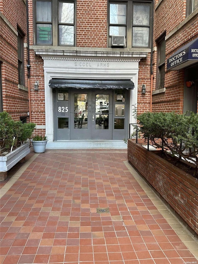 property entrance featuring cooling unit and french doors