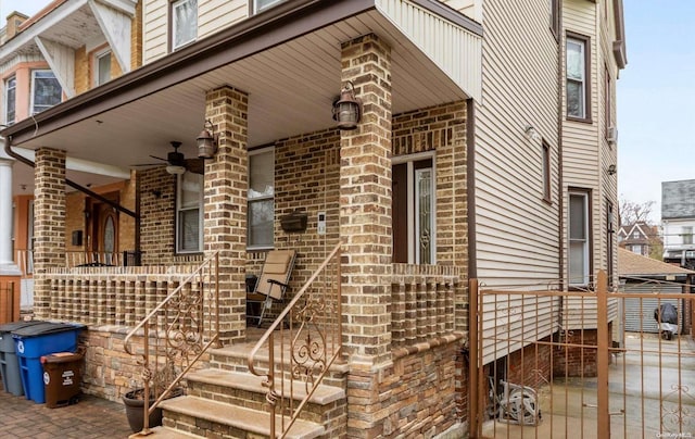 view of side of property with a porch and ceiling fan