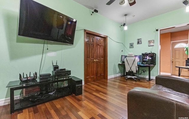 living room with ceiling fan and dark hardwood / wood-style floors