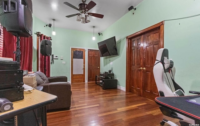 living room with ceiling fan and dark wood-type flooring