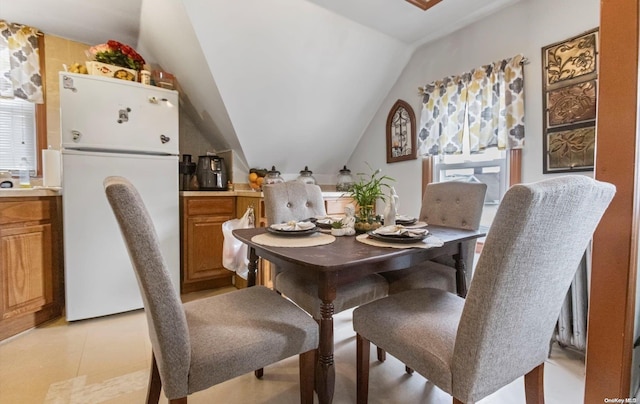 dining room with lofted ceiling