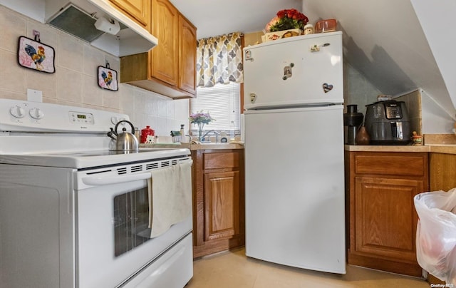 kitchen with decorative backsplash and white appliances