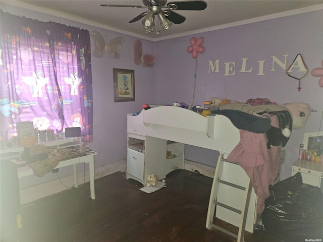 bedroom featuring ceiling fan, dark hardwood / wood-style floors, and ornamental molding