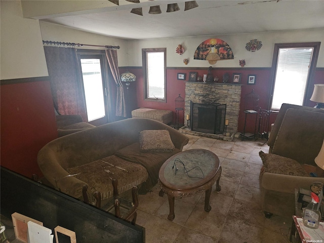 living room featuring a stone fireplace