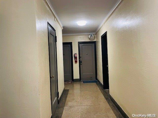 hallway featuring ornamental molding