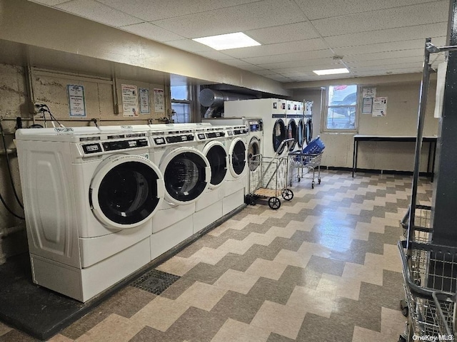 clothes washing area with washer and clothes dryer