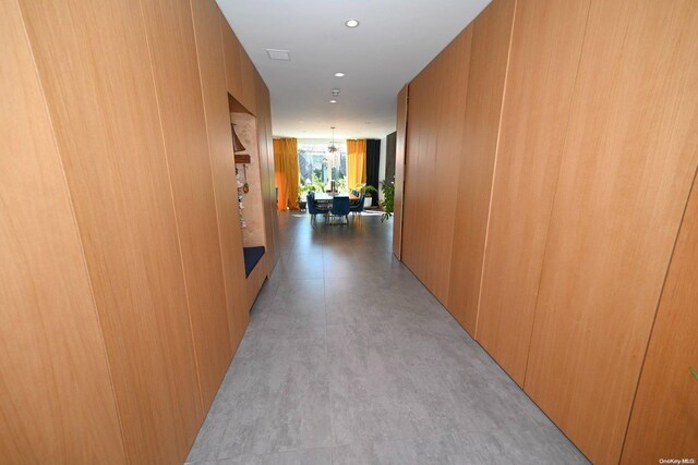 hallway featuring an inviting chandelier