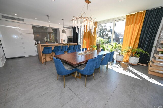 dining room with concrete flooring and an inviting chandelier