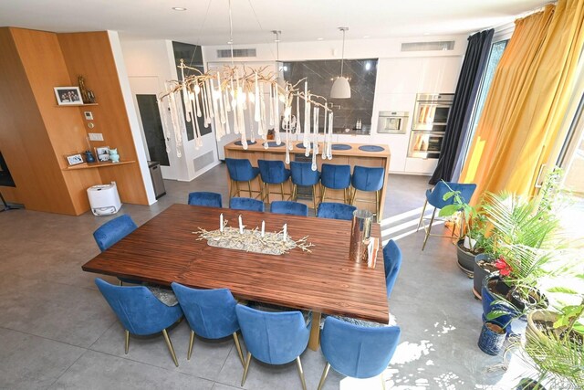 dining space featuring concrete flooring