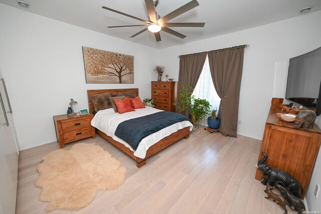 bedroom with ceiling fan and light hardwood / wood-style floors