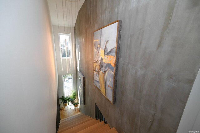 staircase with hardwood / wood-style flooring and a wealth of natural light