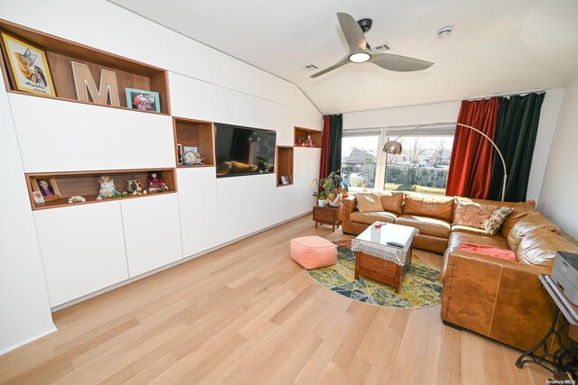 living room with ceiling fan, light hardwood / wood-style floors, and lofted ceiling