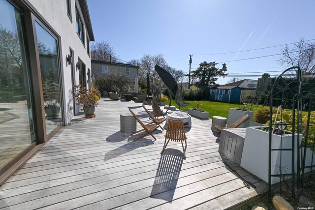 wooden terrace featuring an outdoor hangout area