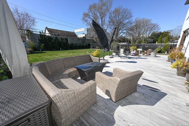 wooden terrace featuring a lawn and an outdoor living space