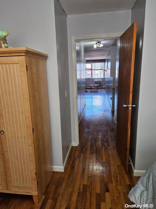 hallway with dark hardwood / wood-style floors