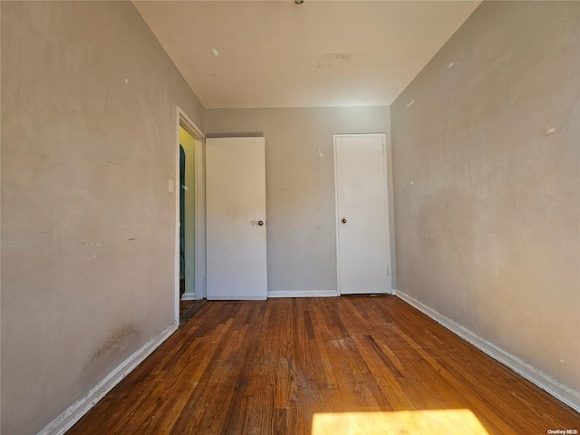 unfurnished bedroom featuring dark wood-type flooring