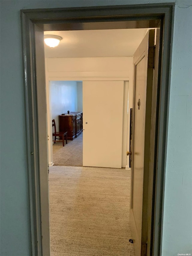 hallway with light colored carpet