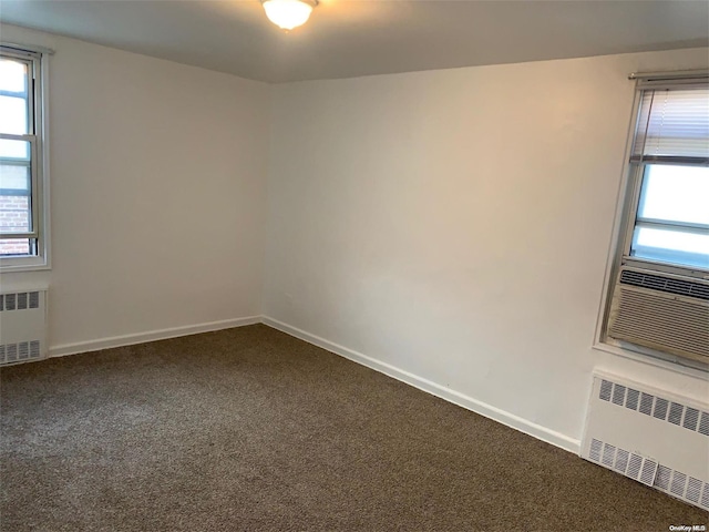 spare room with carpet, radiator, and cooling unit