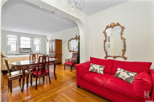 living room with crown molding, cooling unit, and hardwood / wood-style flooring