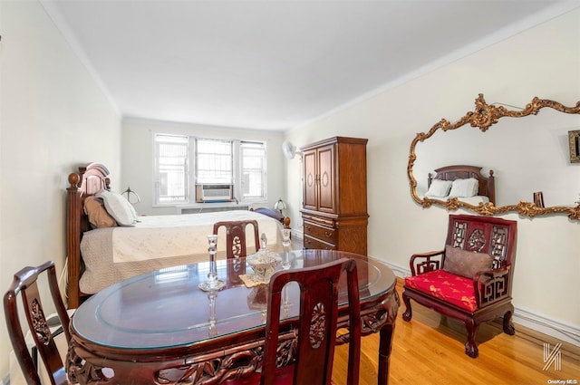 dining room featuring light wood-type flooring and cooling unit