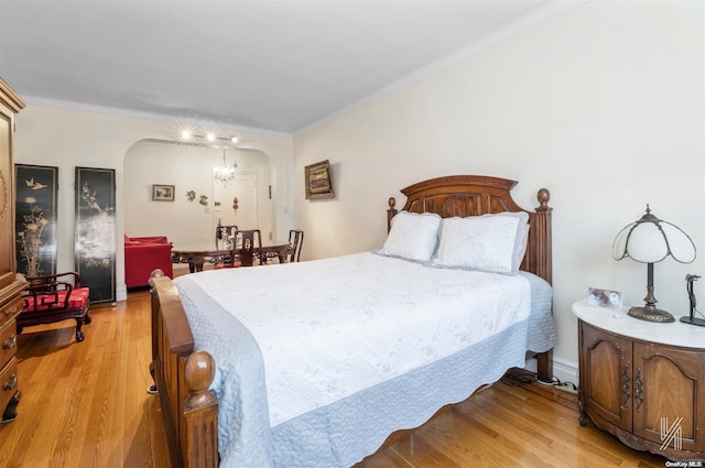 bedroom featuring light hardwood / wood-style flooring and a notable chandelier