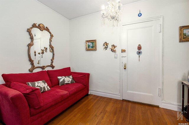 entryway with ornamental molding and hardwood / wood-style flooring