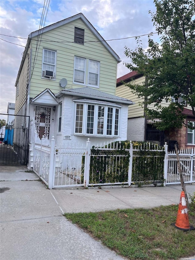 2217 Homer Ave, Bronx, NY 10473 - view of front facade with a gate, a fenced front yard, and cooling unit