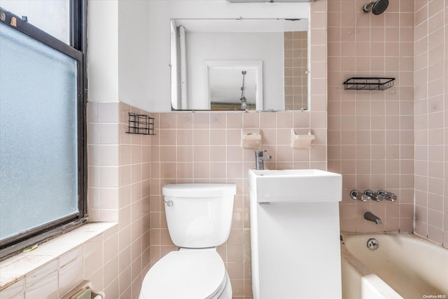 bathroom featuring tiled shower / bath combo, toilet, and tile walls