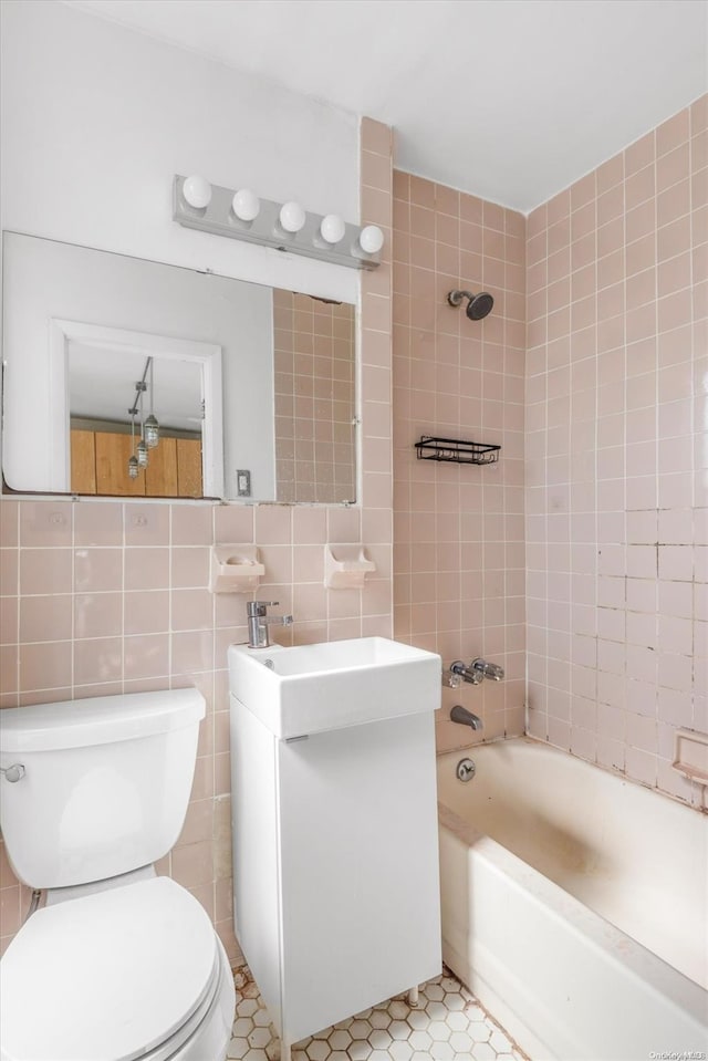 full bathroom featuring tile patterned flooring and tile walls