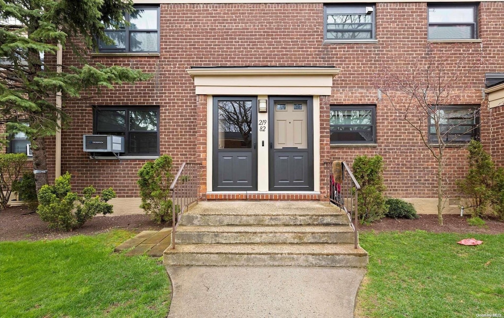 entrance to property with a lawn