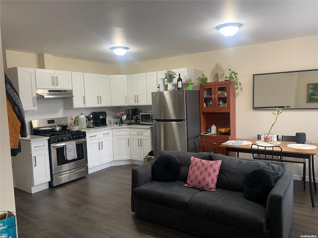 kitchen featuring appliances with stainless steel finishes, dark hardwood / wood-style flooring, and white cabinetry