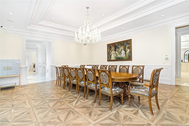 dining room with a notable chandelier, crown molding, a tray ceiling, and light parquet flooring