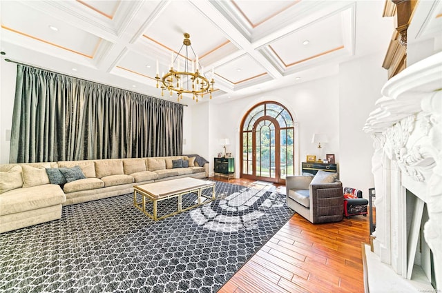 living room with beam ceiling, wood-type flooring, crown molding, and coffered ceiling