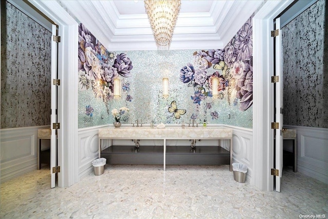 bathroom with crown molding and a chandelier