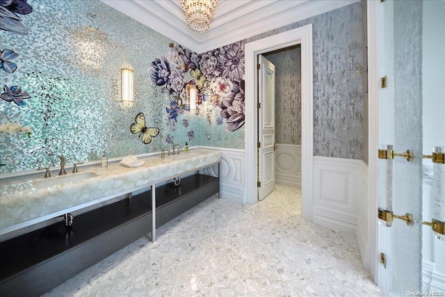 bathroom featuring vanity, ornamental molding, and a chandelier