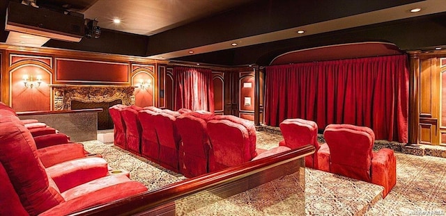 cinema featuring decorative columns and a high end fireplace