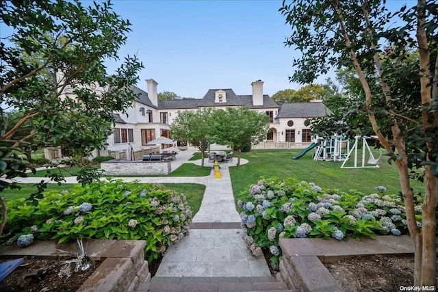 view of yard featuring a playground and a patio area