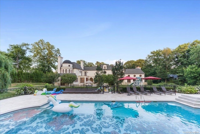 view of swimming pool with a patio