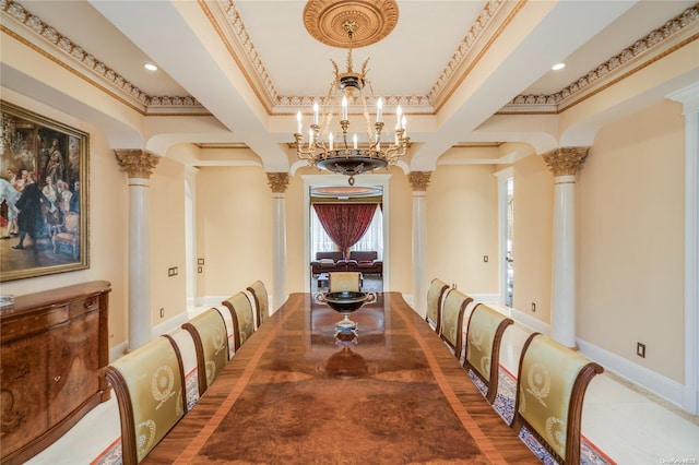 dining area with hardwood / wood-style flooring, ornamental molding, and decorative columns