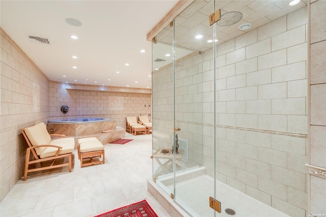 bathroom featuring tile patterned floors, tile walls, and shower with separate bathtub