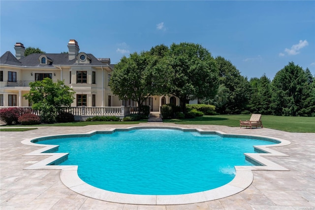 view of pool with a yard