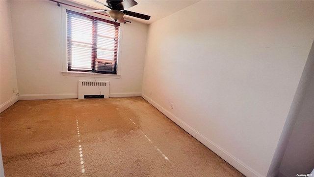 carpeted spare room with radiator heating unit, cooling unit, and ceiling fan