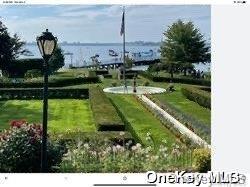 surrounding community featuring a lawn and a water view